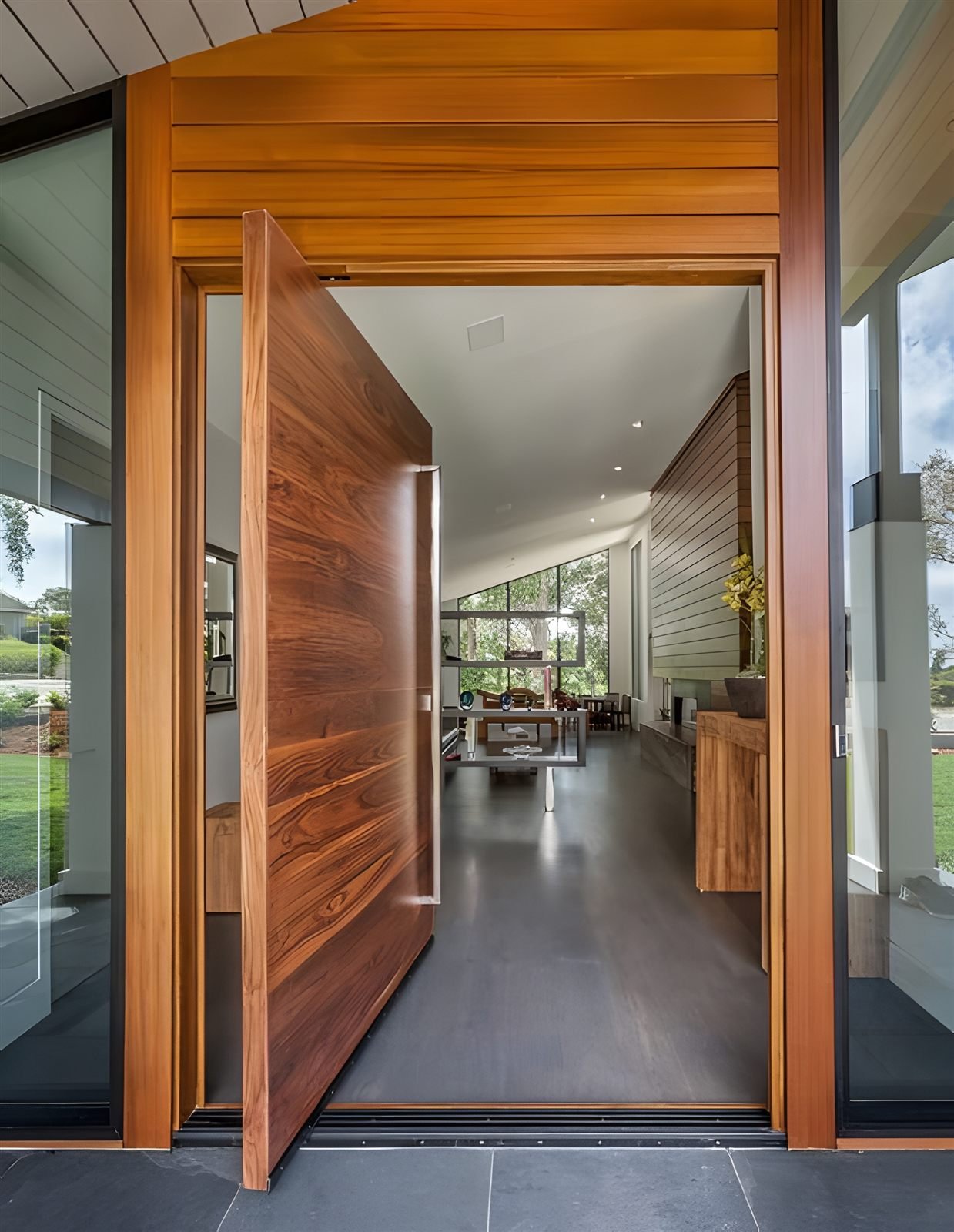 Open wood finish pivot door villa