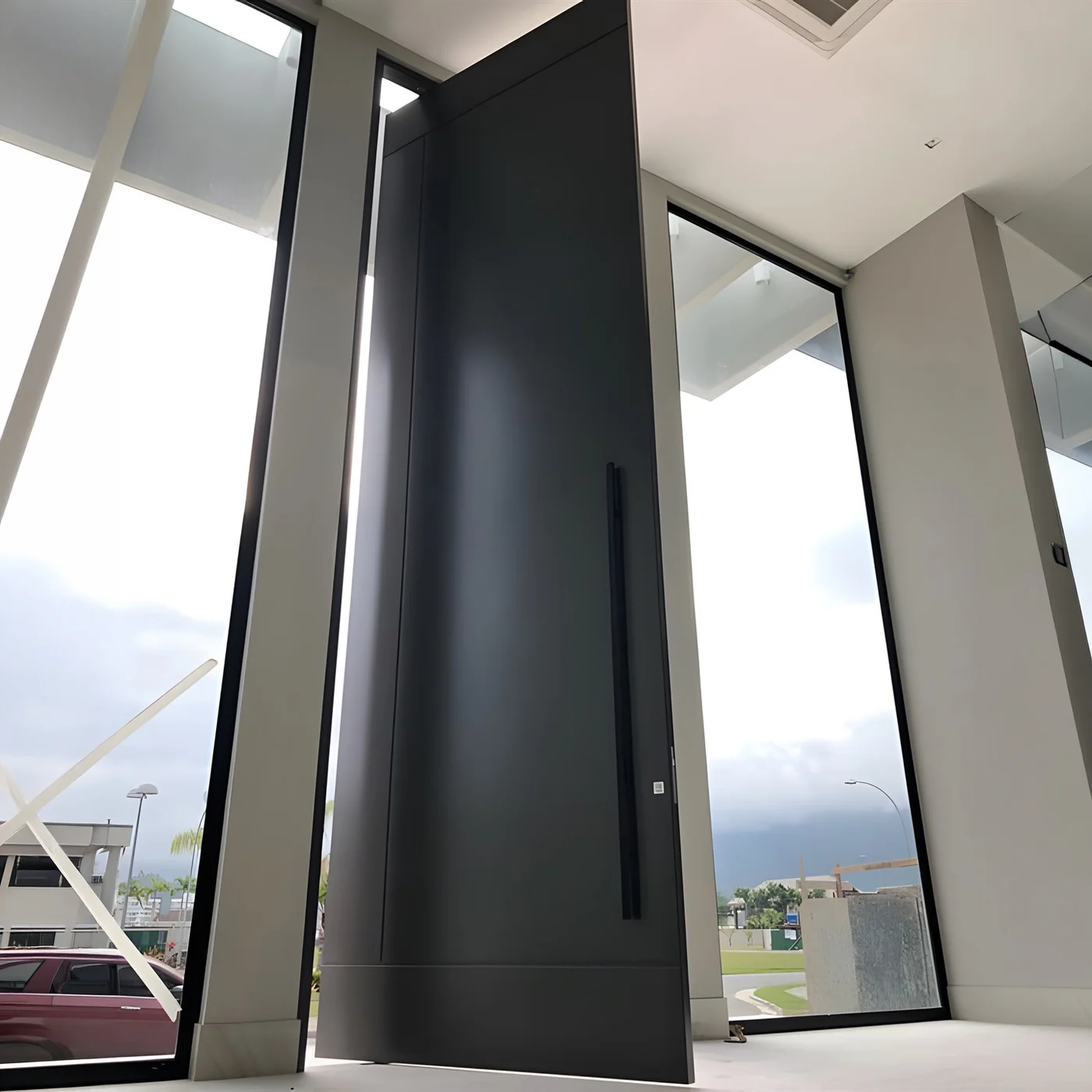 AsvntDoor Aluminium Pivot Doors Plain dark aluminium pivot door shown open beside a glass side panel